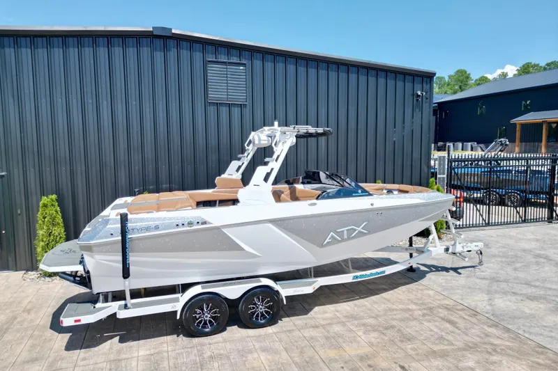 Slide: The Image of 2027 ATX Surf Boats 22 Type-S on trailer, parked outdoors near black building. - 4
