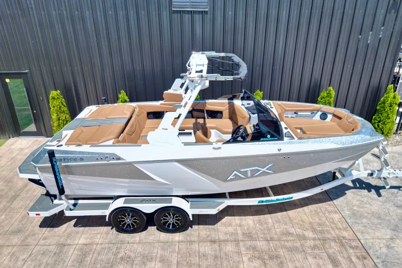Slide: The Image of 2027 ATX Surf Boats 22 Type-S on trailer, sleek design, brown seating, modern features. - 17