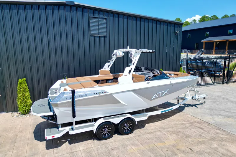 Slide: The Image of 2027 ATX Surf Boats 22 Type-S on trailer, parked outside a modern building. - 5
