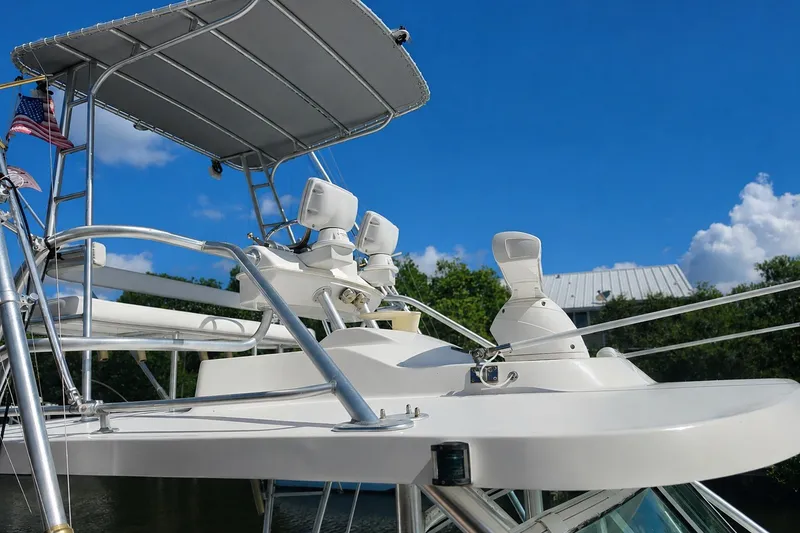 Slide: The Image of 2005 Luhrs 32 Open boat with radar equipment and canopy against blue sky. - 7