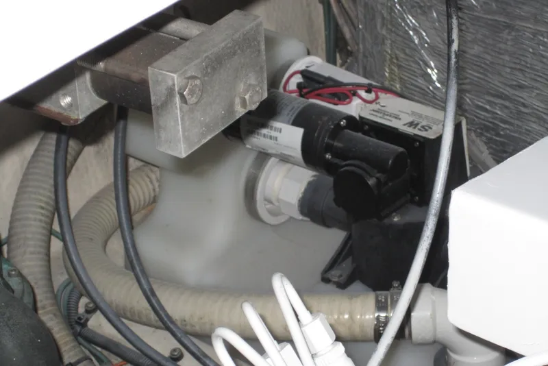 Slide: The Image of Engine compartment of a 2005 Luhrs 32 Open boat, featuring mechanical components and wiring. - 40
