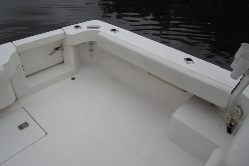 Slide: The Image of 2005 Luhrs 32 Open boat deck with clean white surface and storage compartments. - 18