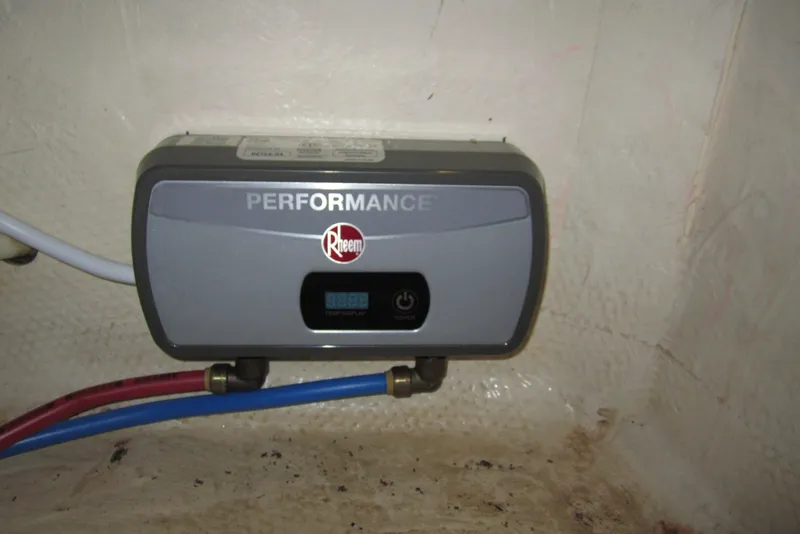 Slide: The Image of Rheem Performance water heater installed on a 2005 Luhrs 32 Open boat. - 31