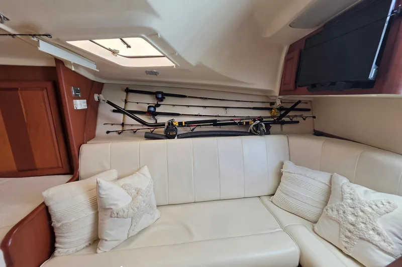 Slide: The Image of Interior of 2005 Luhrs 32 Open boat with fishing rods and cozy seating area. - 25