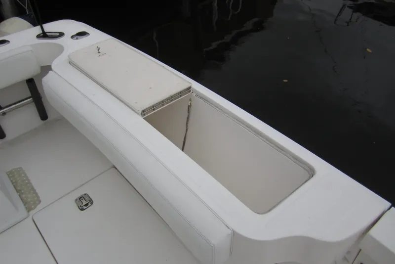 Slide: The Image of 2005 Luhrs 32 Open boat storage compartment with white cushioned seating. - 19
