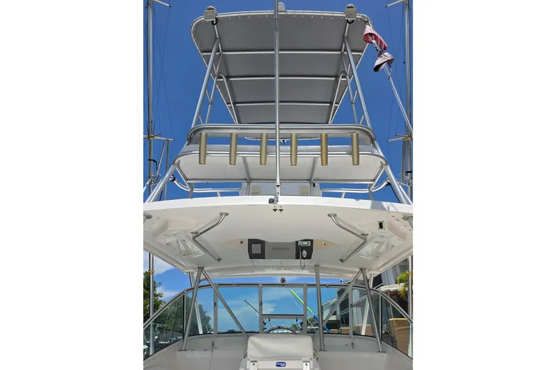 Slide: The Image of 2005 Luhrs 32 Open boat with tower and rod holders against clear blue sky. - 8