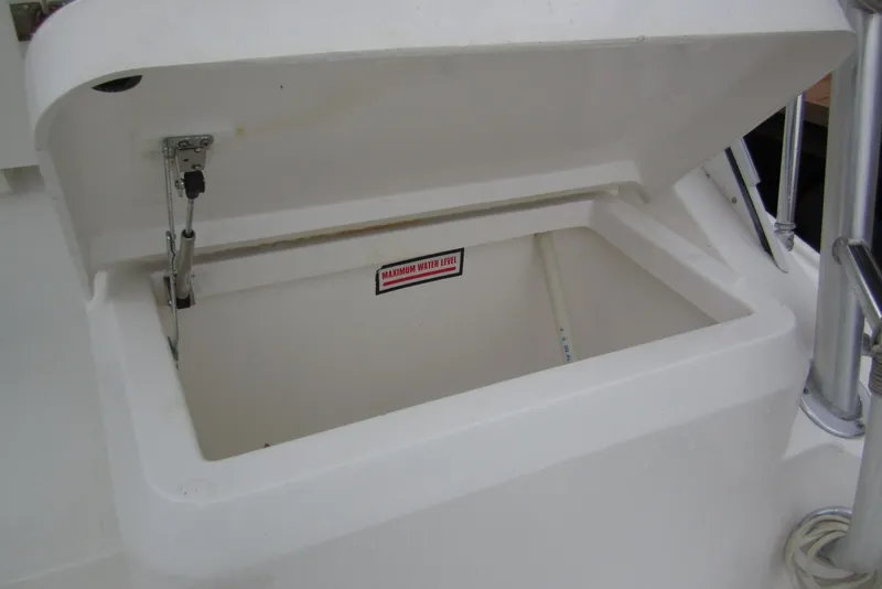 Slide: The Image of Open storage compartment on a 2005 Luhrs 32 Open boat, showing maximum water level indicator. - 21