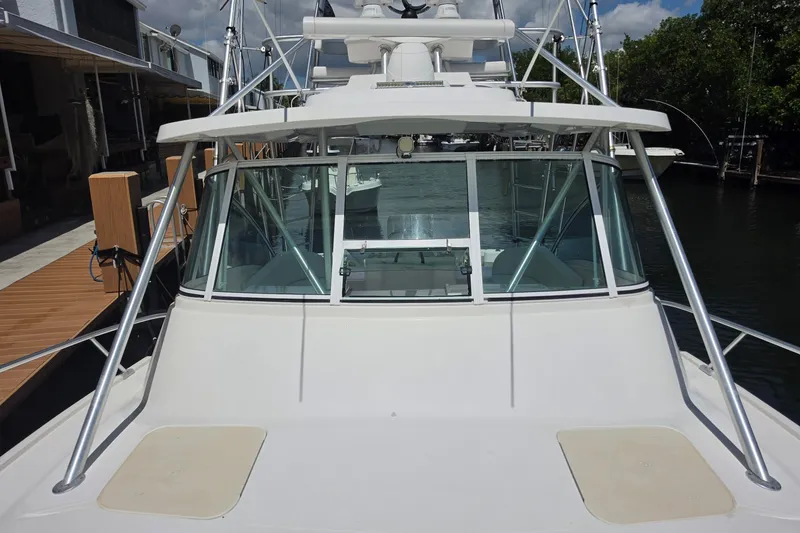 Slide: The Image of 2005 Luhrs 32 Open boat docked, showcasing front deck and windshield. - 5