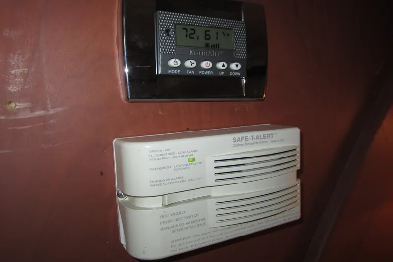 Slide: The Image of Thermostat and carbon monoxide alarm on 2005 Luhrs 32 Open boat interior. - 29
