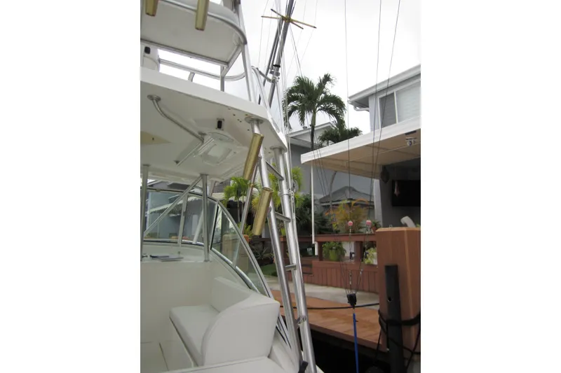 Slide: The Image of 2005 Luhrs 32 Open boat docked, featuring a sleek design and fishing equipment. - 23