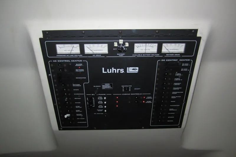 Slide: The Image of Control panel of a 2005 Luhrs 32 Open boat, featuring AC and DC systems. - 28