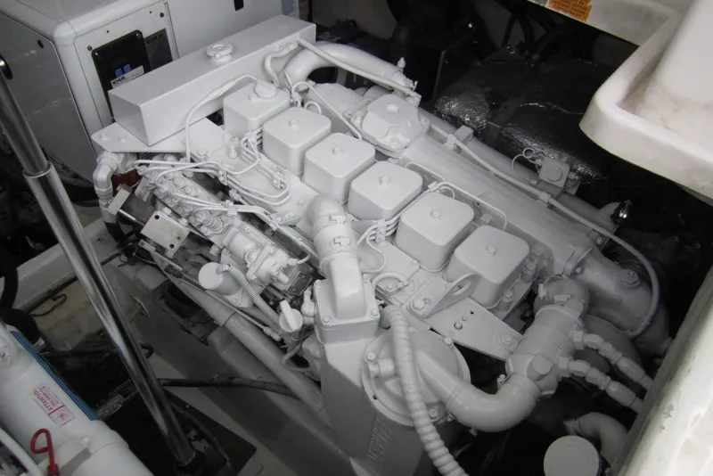 Slide: The Image of Engine compartment of a 2005 Luhrs 32 Open boat, showcasing a clean, well-maintained engine. - 36
