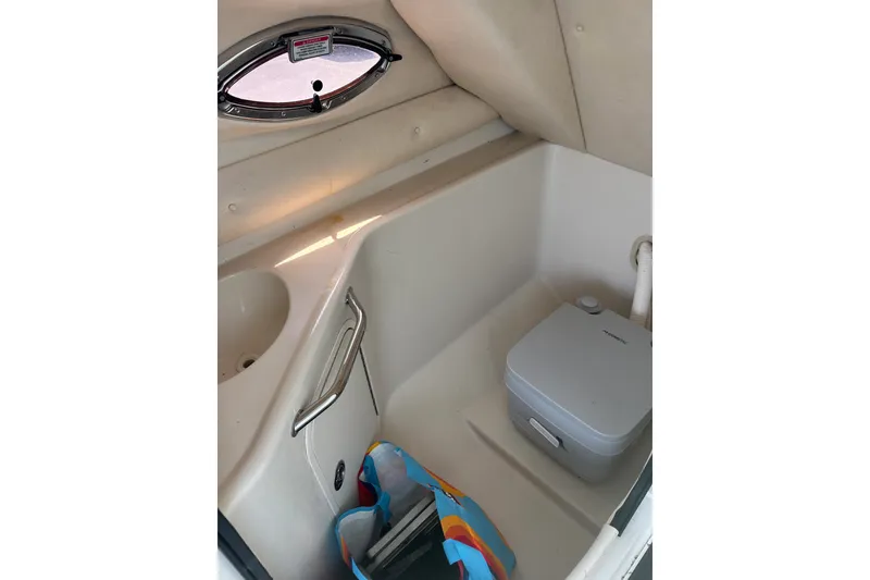 Slide: The Image of Interior of 2006 Sea Ray 240 Sundeck boat with compact toilet and sink. - 23