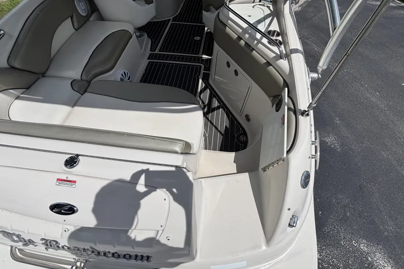 Slide: The Image of 2006 Sea Ray 240 Sundeck interior with seating and storage compartments. - 51