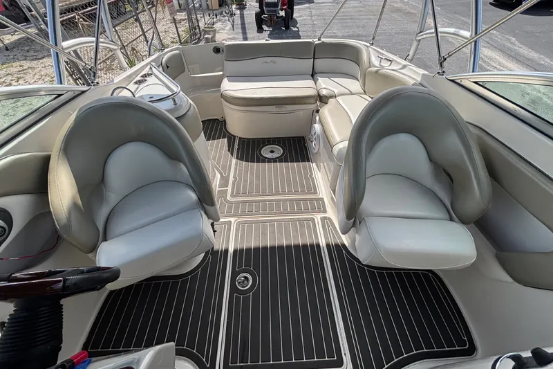 Slide: The Image of 2006 Sea Ray 240 Sundeck interior with seating and sleek flooring design. - 35