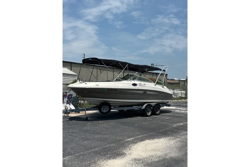 Slide: The Image of 2006 Sea Ray 240 Sundeck boat on trailer under clear sky. - 49