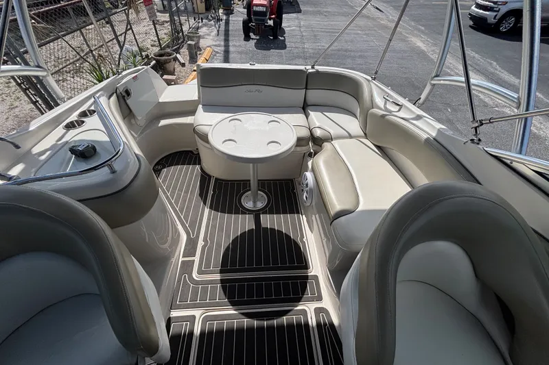 Slide: The Image of 2006 Sea Ray 240 Sundeck interior with seating and table, showcasing luxury boat design. - 44