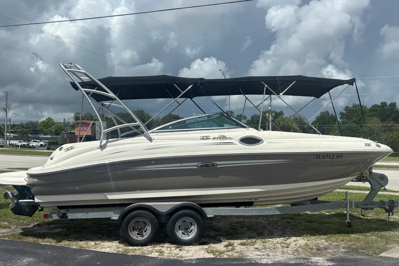 Slide: The Image of 2006 Sea Ray 240 Sundeck boat on trailer under cloudy sky. - 15