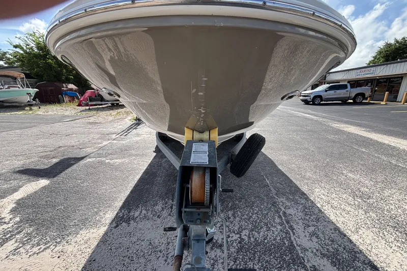 Slide: The Image of 2006 Sea Ray 240 Sundeck boat on trailer, parked outdoors on a sunny day. - 12