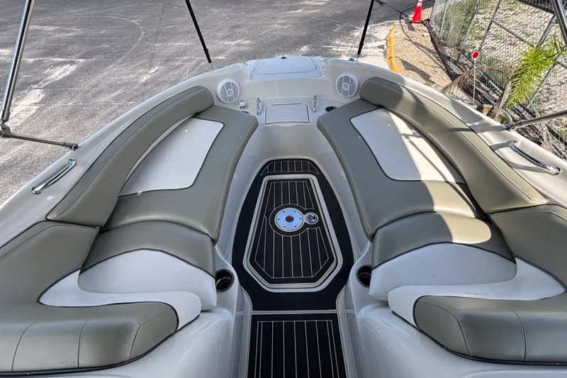 Slide: The Image of 2006 Sea Ray 240 Sundeck interior with cushioned seating and sleek flooring. - 17