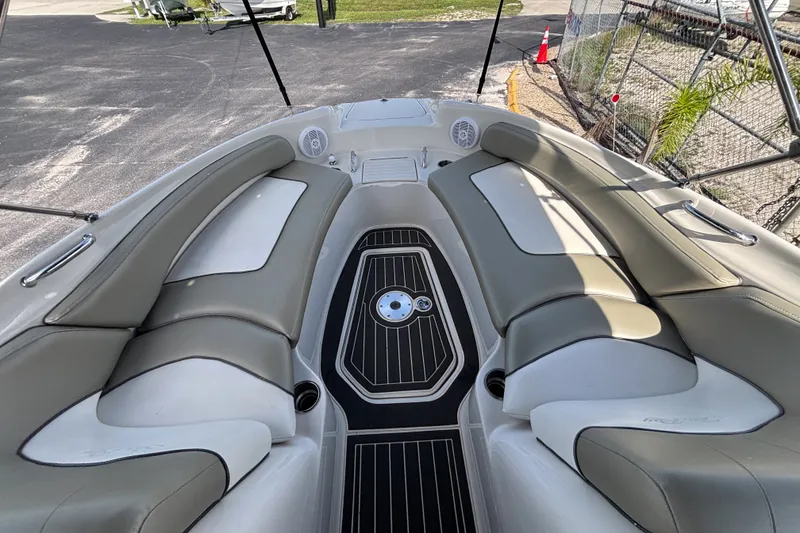 Slide: The Image of 2006 Sea Ray 240 Sundeck interior with cushioned seating and sleek flooring. - 34
