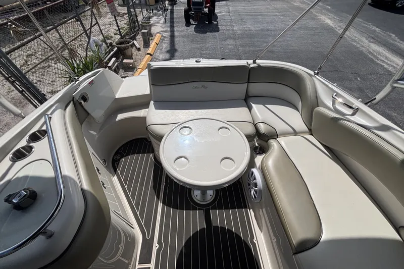 Slide: The Image of 2006 Sea Ray 240 Sundeck interior with seating and table, showcasing elegant design and comfort. - 27