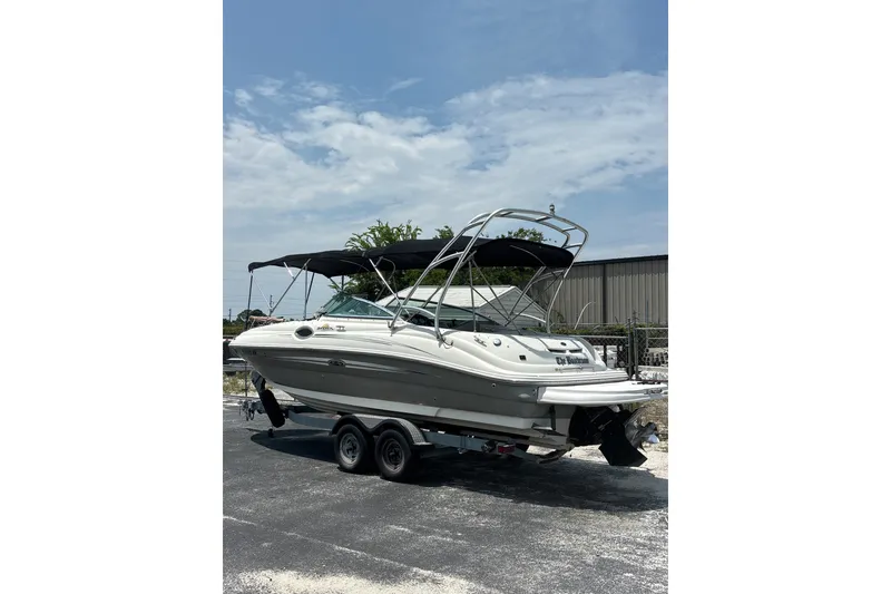 Slide: The Image of 2006 Sea Ray 240 Sundeck boat on trailer under clear sky. - 59