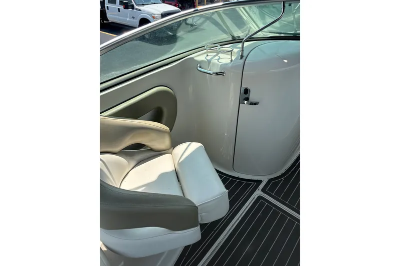 Slide: The Image of Interior of a 2006 Sea Ray 240 Sundeck boat with seating and cup holders. - 21