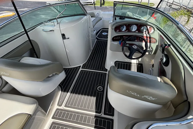 Slide: The Image of Interior view of 2006 Sea Ray 240 Sundeck boat with steering wheel and seating. - 16