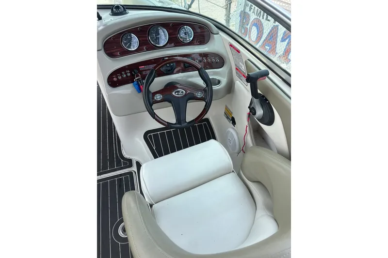 Slide: The Image of 2006 Sea Ray 240 Sundeck helm with steering wheel and instrument panel. - 55