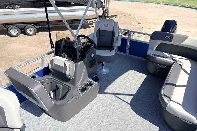 Slide: The Image of 2027 Sun Tracker Party Barge 16 DLX interior with seating and steering console. - 15