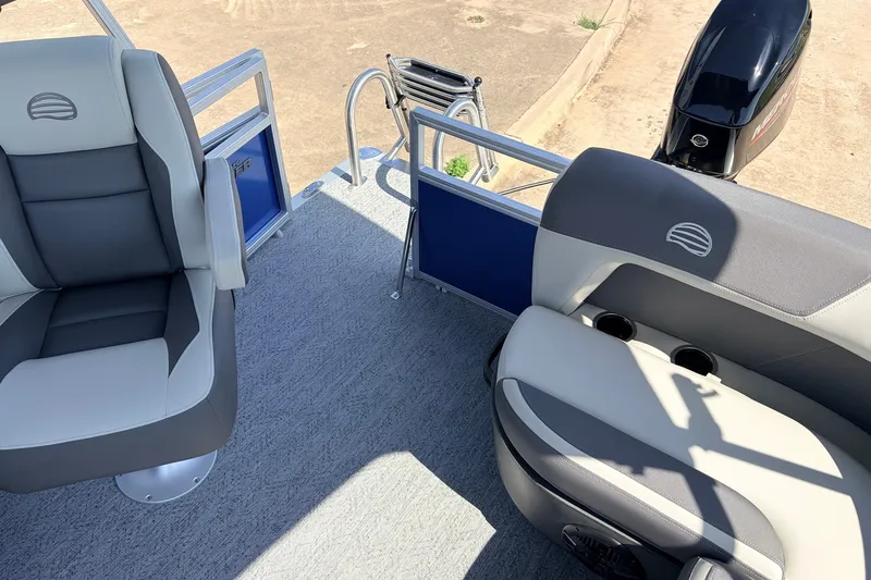 Slide: The Image of 2027 Sun Tracker Party Barge 16 DLX interior with seating and motor, showcasing modern design. - 24