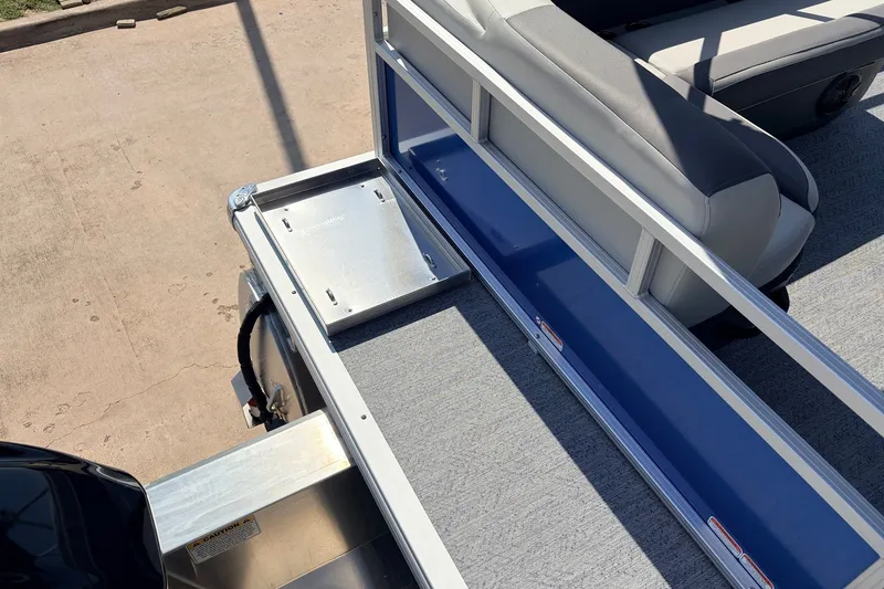 Slide: The Image of 2027 Sun Tracker Party Barge 16 DLX interior with seating and storage area. - 25
