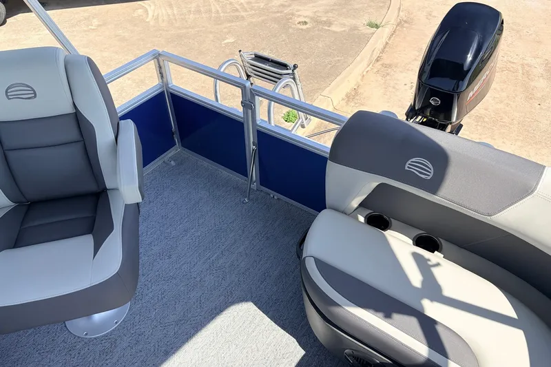 Slide: The Image of 2027 Sun Tracker Party Barge 16 DLX interior with seating and outboard motor. - 23