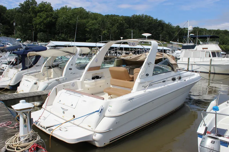 Slide: The Image of 2000 Sea Ray Sundancer 310 docked at marina, surrounded by other boats. - 13