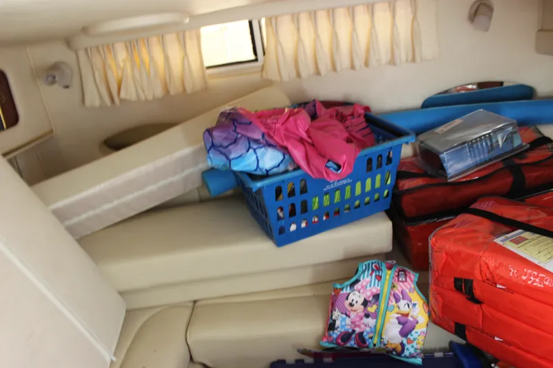 Slide: The Image of Interior of a 2000 Sea Ray Sundancer 310 with storage items and life jackets. - 24