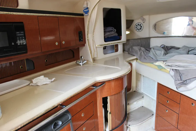 Slide: The Image of Interior of 2000 Sea Ray Sundancer 310 yacht with kitchenette and sleeping area. - 20