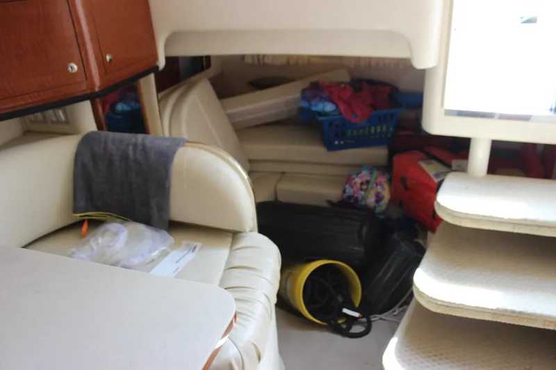 Slide: The Image of Interior of a 2000 Sea Ray Sundancer 310 with seating and storage items. - 23