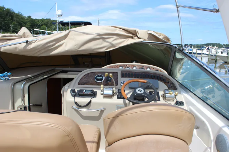 Slide: The Image of Cockpit of a 2000 Sea Ray Sundancer 310 boat with steering wheel and controls. - 9