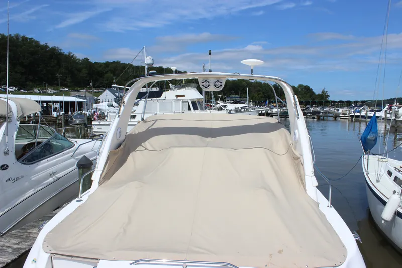 Slide: The Image of 2000 Sea Ray Sundancer 310 docked at a marina under a clear blue sky. - 32
