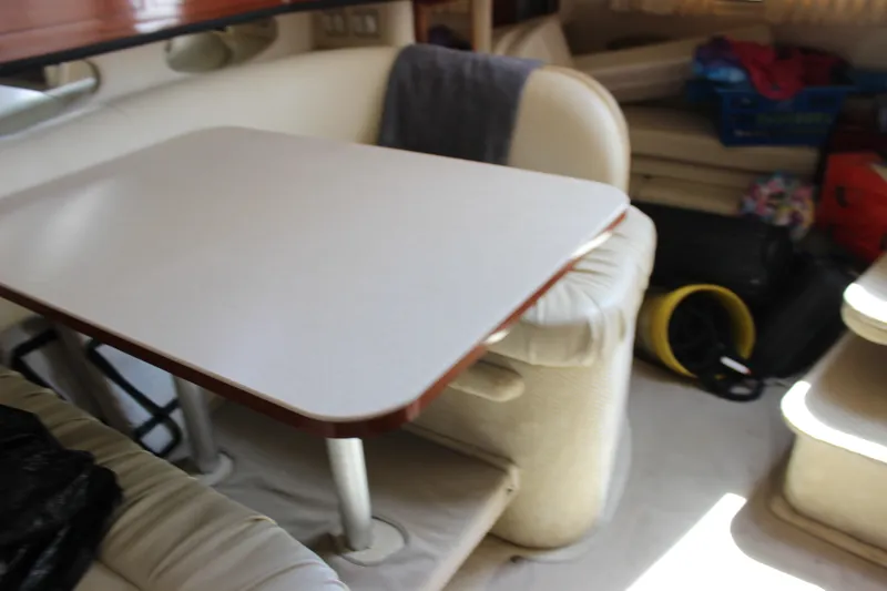 Slide: The Image of Interior of 2000 Sea Ray Sundancer 310 with dining area and seating. - 22