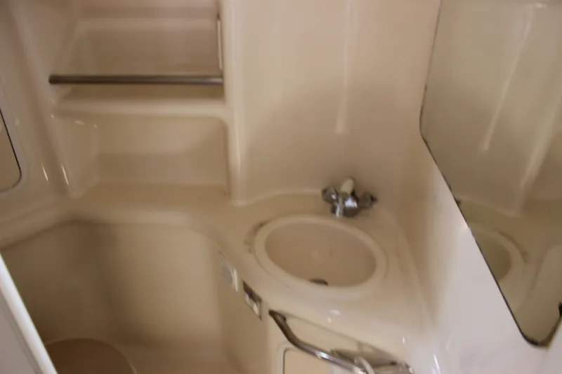 Slide: The Image of Interior of 2000 Sea Ray Sundancer 310 boat bathroom with sink and mirror. - 28