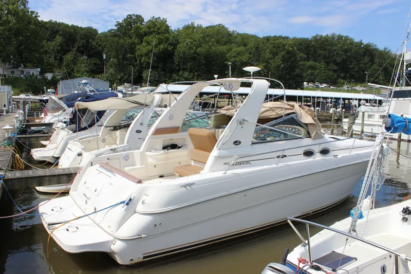 Slide: The Image of 2000 Sea Ray Sundancer 310 docked at marina, surrounded by other boats. - 14