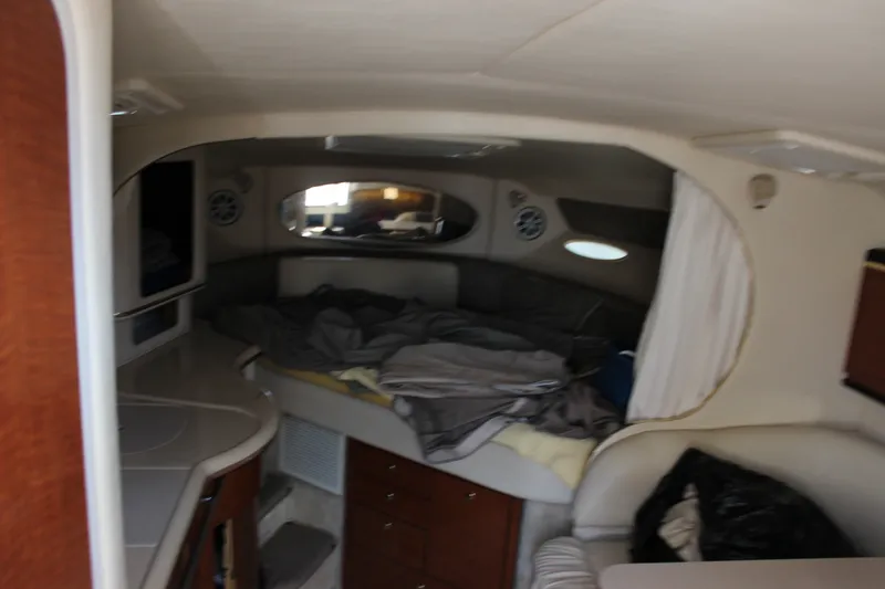 Slide: The Image of Interior cabin of 2000 Sea Ray Sundancer 310 with bed and storage cabinets. - 18