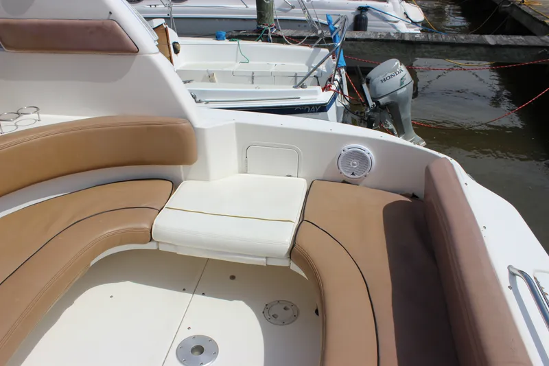 Slide: The Image of Interior seating of a 2000 Sea Ray Sundancer 310 boat at a marina. - 7