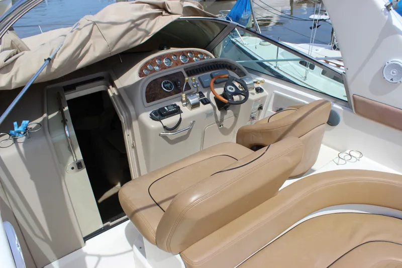 Slide: The Image of Interior view of a 2000 Sea Ray Sundancer 310 boat cockpit with tan seating. - 15