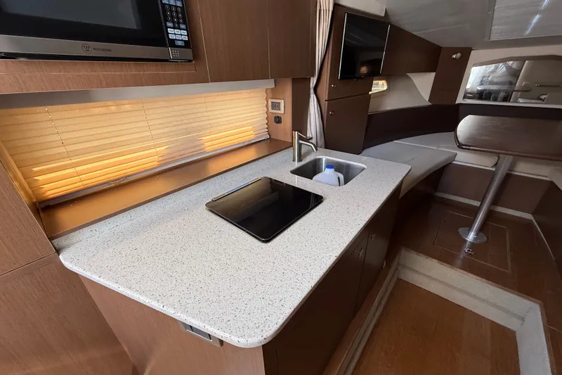 Slide: The Image of Luxurious interior of 2012 Sea Ray Sundancer 310 yacht with modern kitchen amenities. - 23