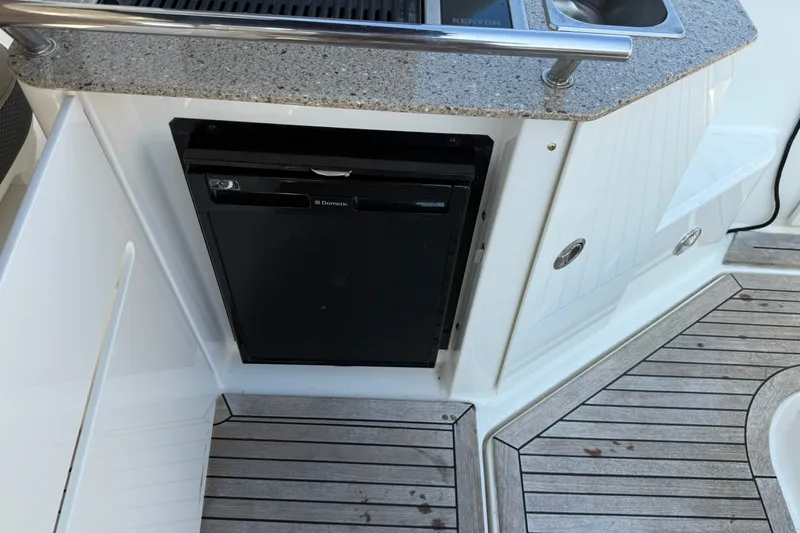 Slide: The Image of 2012 Sea Ray Sundancer 310 boat kitchenette with Dometic fridge and sink. - 25