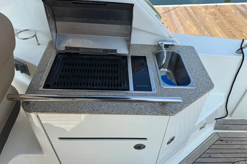 Slide: The Image of Outdoor kitchenette on a 2012 Sea Ray Sundancer 310 yacht with grill and sink. - 14