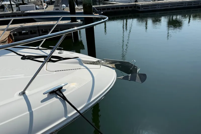 Slide: The Image of 2012 Sea Ray Sundancer 310 anchored at marina, showcasing sleek bow design. - 7